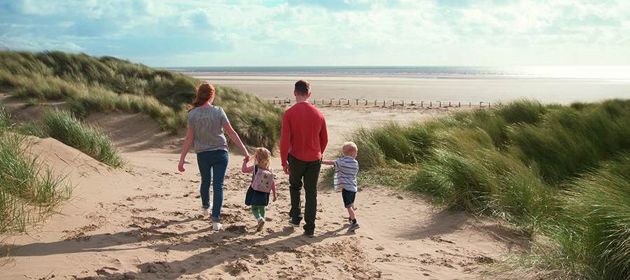 CHECT photo - stock photo of a family of four on a beach in the UK