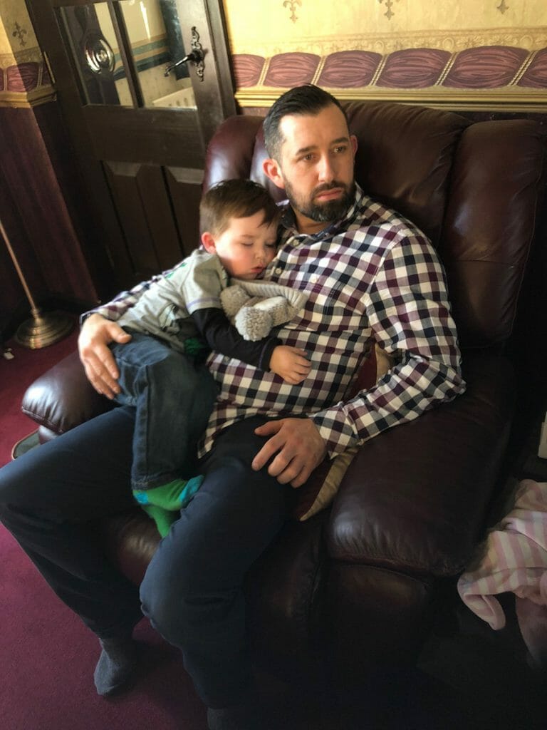 CHECT photo - Gavin Brown and his son Logan, sitting on the sofa cuddling