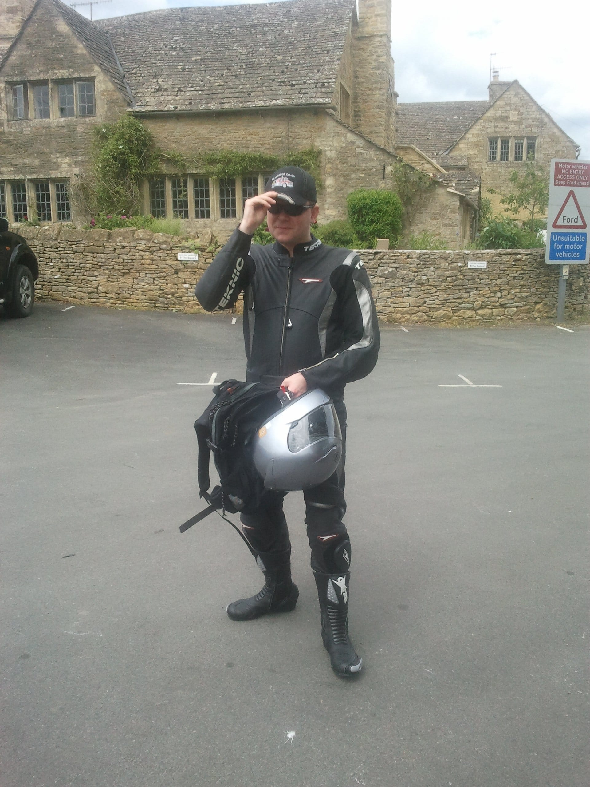 Iain Riddell holding his motor cycle helmet