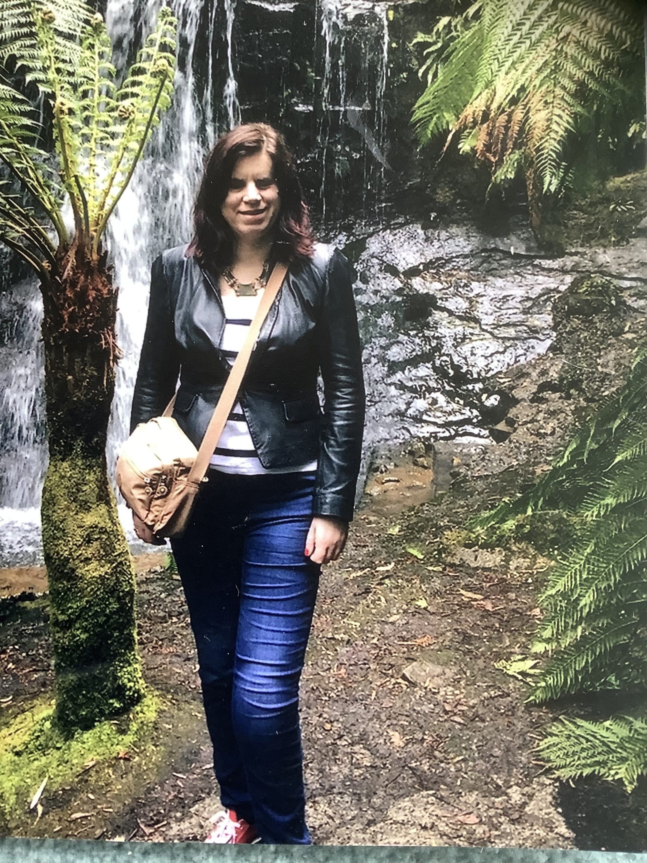 Ffion standing next to a  waterfall