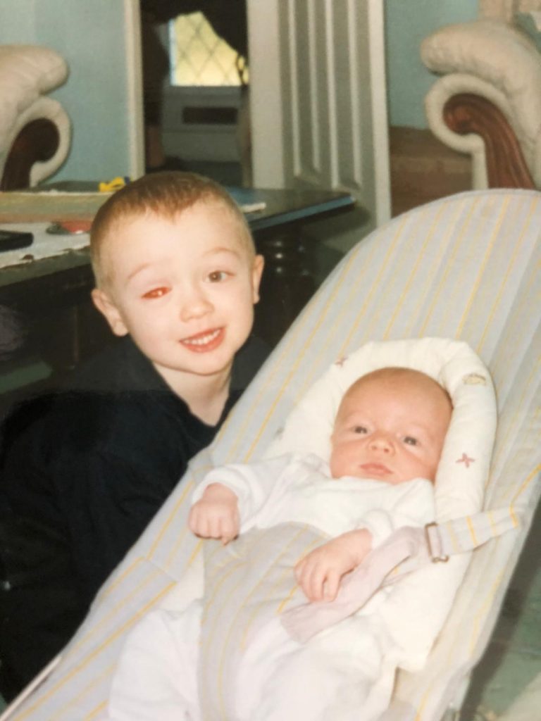 Will as a toddler with his new baby brother Tom