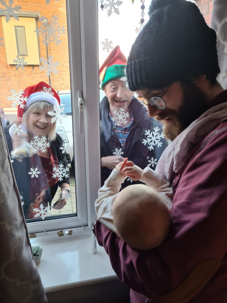 Imogen lloyd seeing her grandparents through the window at Christmas