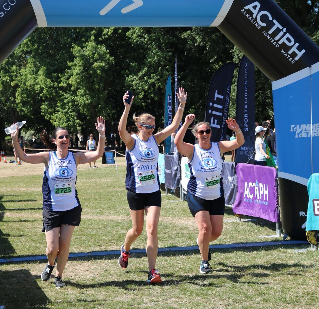 Three CHECT runners going through the finish line