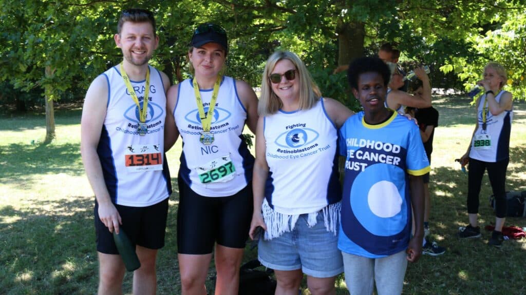 Runners and supporters in Team CHECT vests and tops smiling