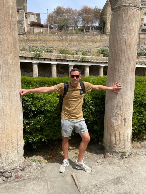 Dan stood by two pillars smiling