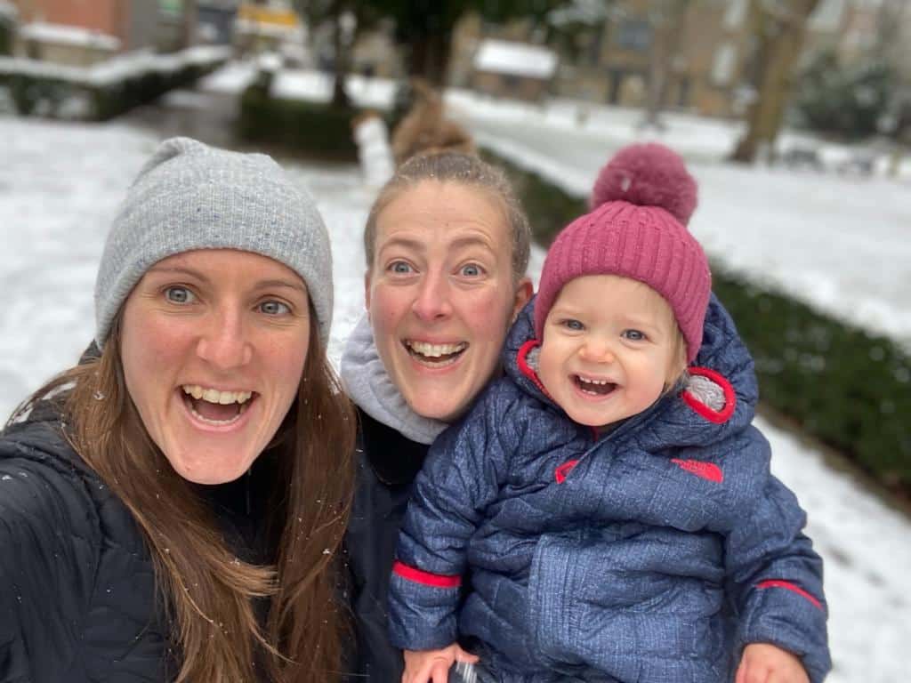 Isla is in the snow with her parents