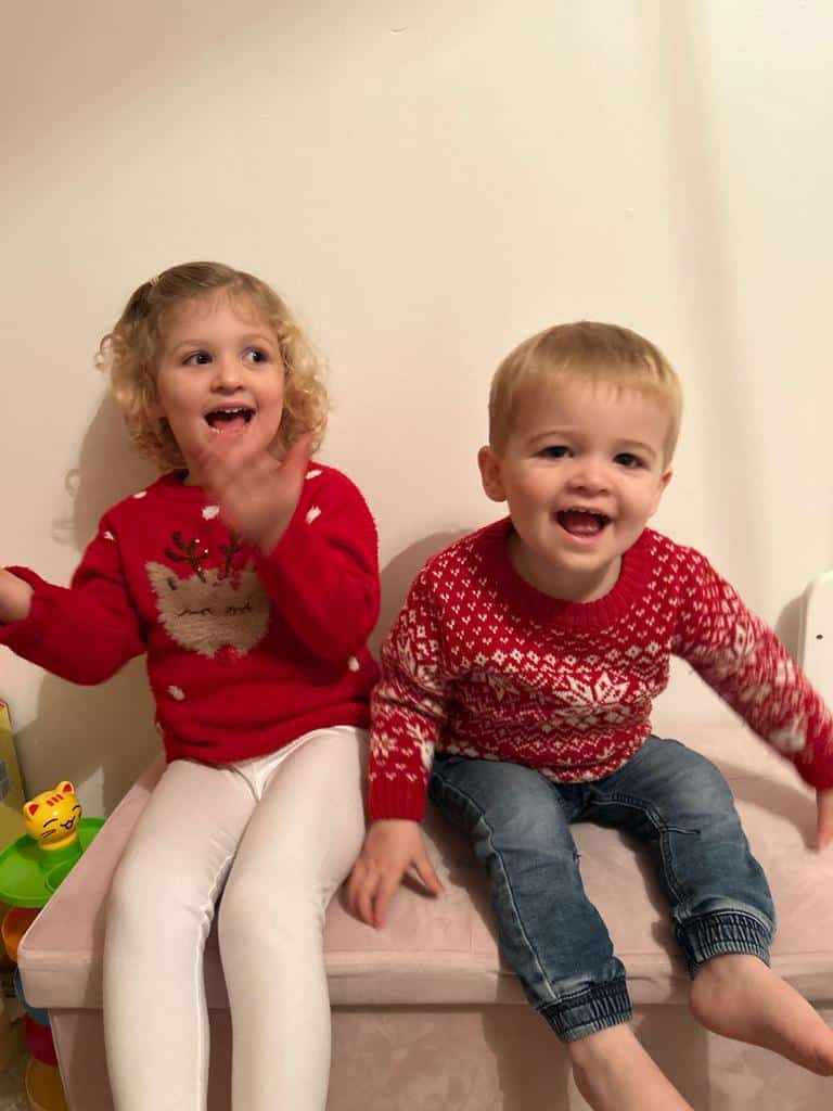 Cian and his sister in Christmas jumpers