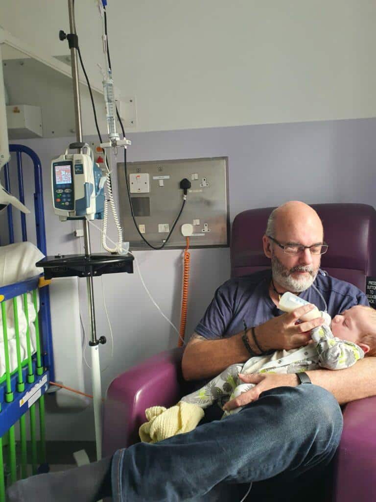 Thomas' dad feeding Thomas in hospital