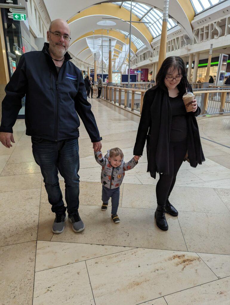 Thomas walking with his sister and dad