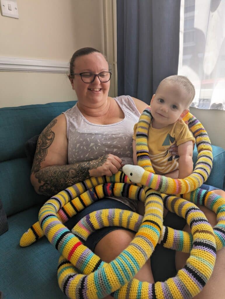 Thomas with a 'chemo snake' a friend made. Each colour represents something he had done