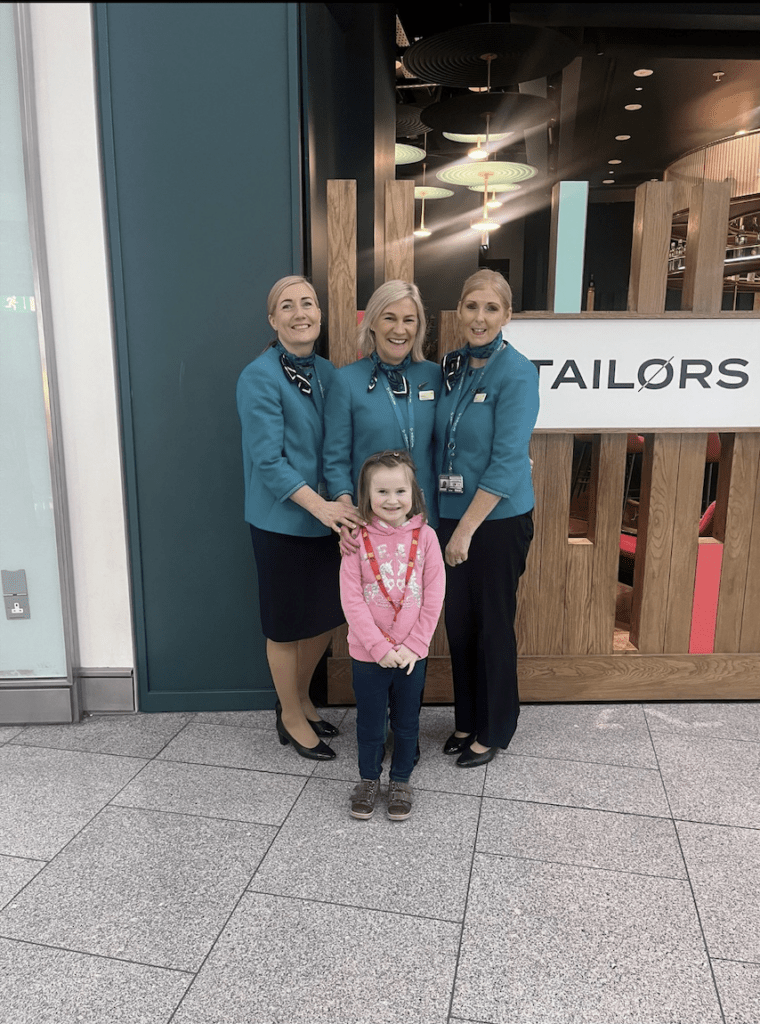 Rachel happy with air hostesses