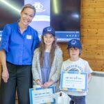 Lena with two child who are holding their CHECT Champion certificates