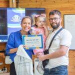 Lena with a dad and daughter who are holding their CHECT Champion certificates