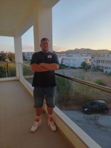 Dad is stood on a balcony on holiday