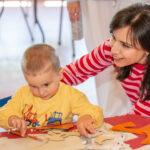 A mum and child doing and and crafts