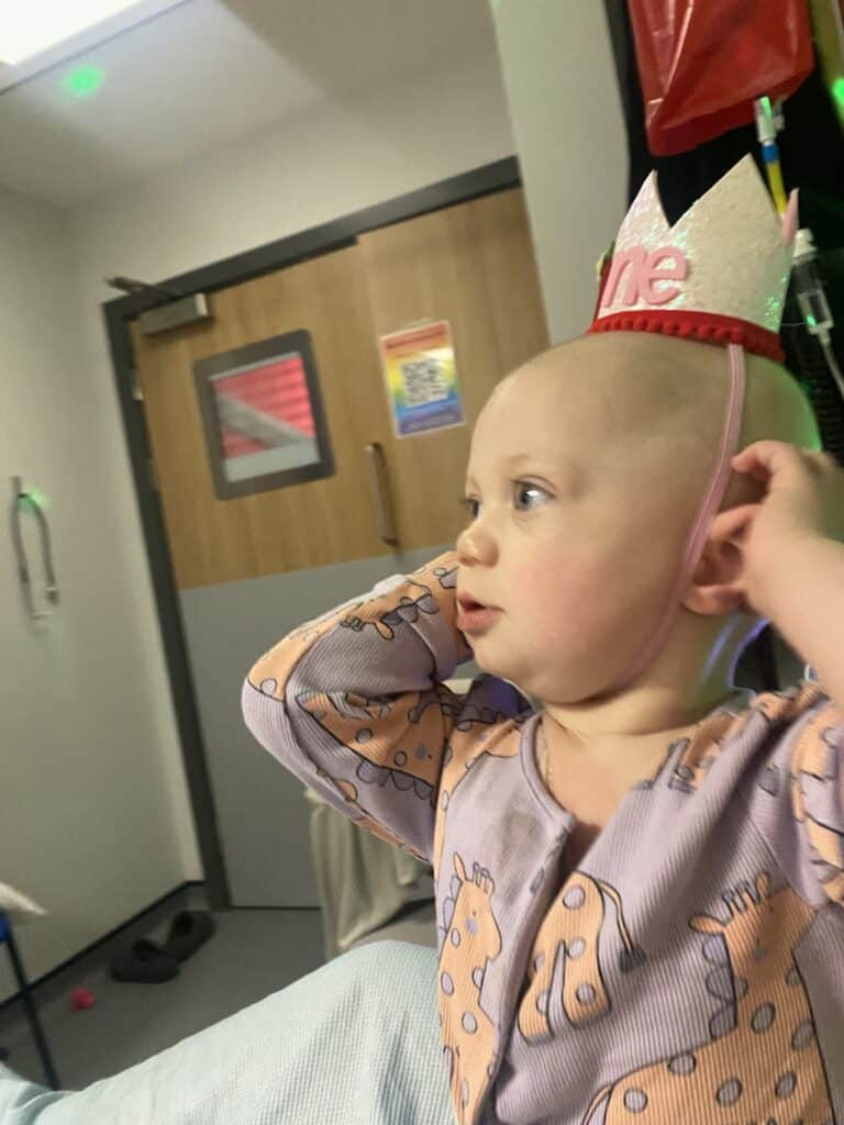 Raye with a 'one' crown on her head for her birthday